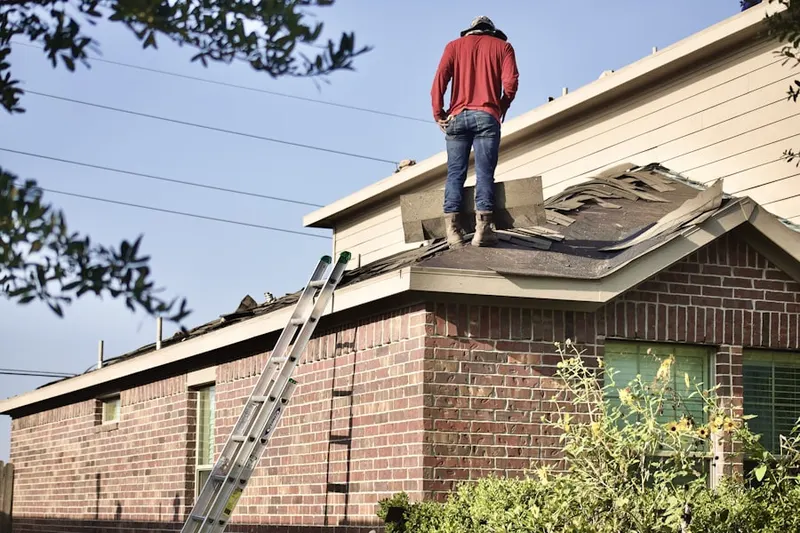Professional roofer working on a residential roof in Fieldville